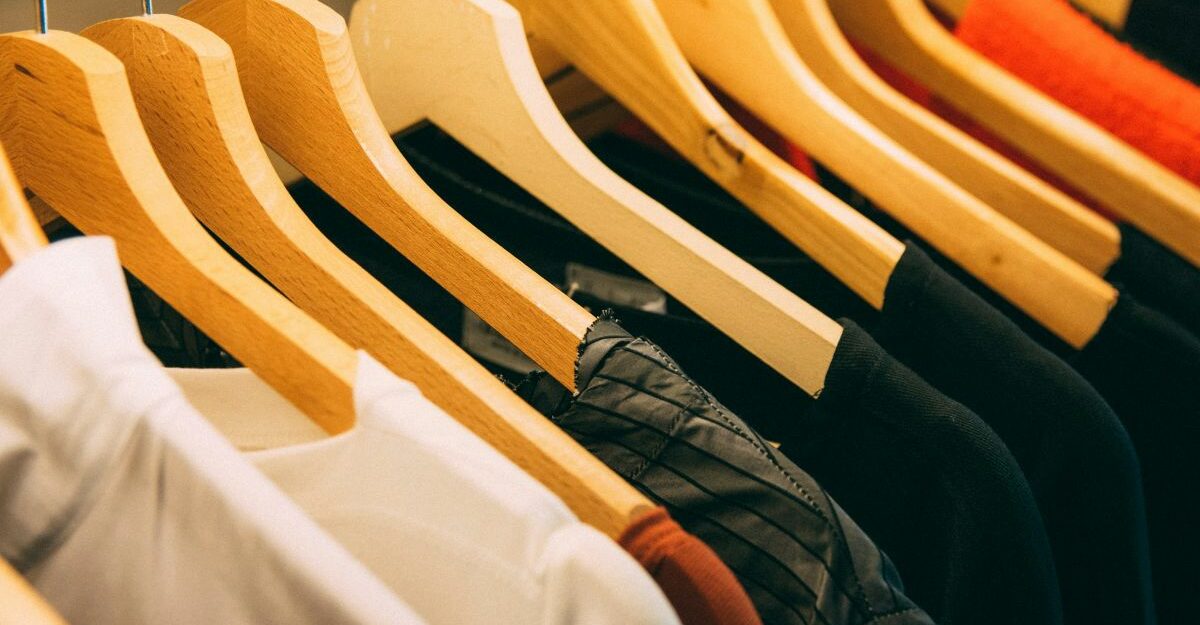 Various items of clothing sit on hangers.
