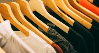 Various items of clothing sit on hangers.