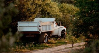 A photo of a truck parked on the side of the road in a wooded area. (Photo: Laura Ohlman / Unsplash)