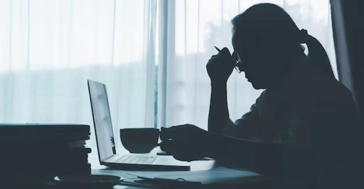 canada-post-worker-denied-long-term-disability-may-2025 A photo of a person rubbing their forehead while staring at a laptop. (Photo: dapor2560 / Freepik)
