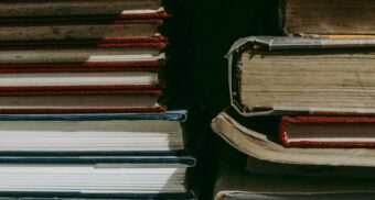 chegg-layoffs-severance A photo of textbooks stacked on top of each other. (Photo: hubiita / Unsplash)
