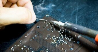 A photo of a person using a soldering iron. (Photo: Blaz Erzetic / Unsplash)