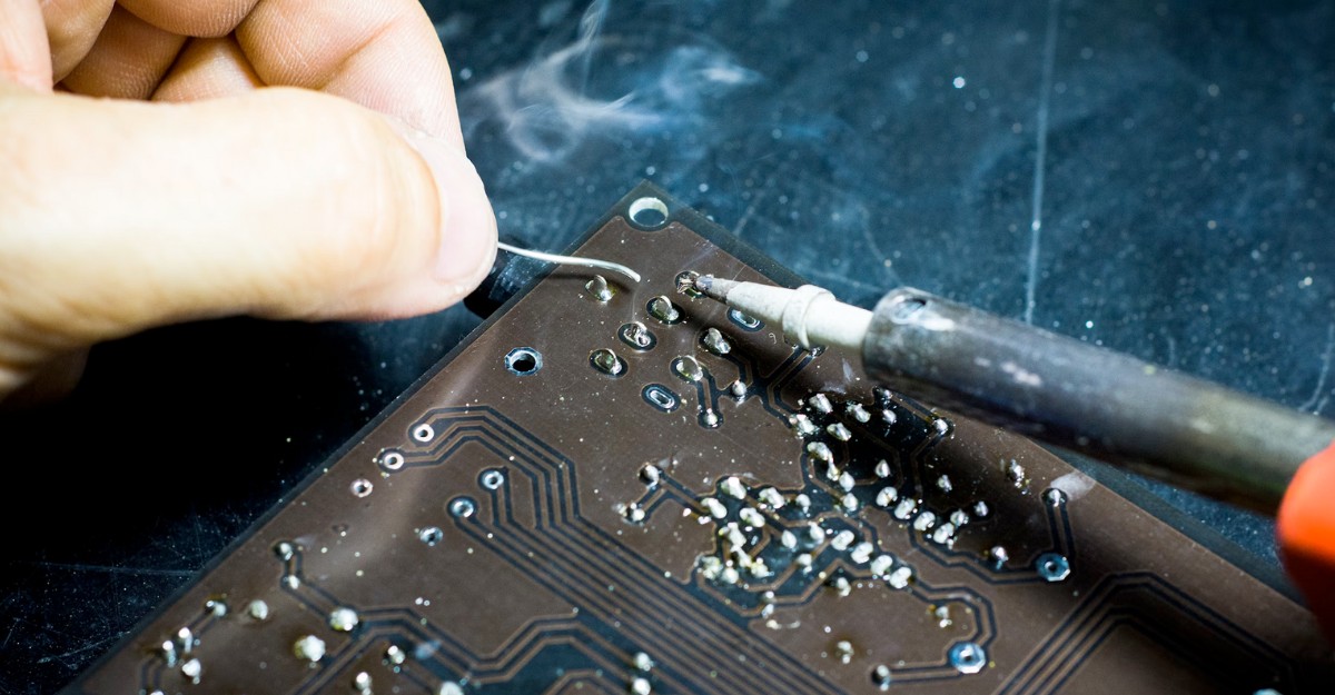 kaynes-canada-acquiring-august-electronics-rights A photo of a person using a soldering iron. (Photo: Blaz Erzetic / Unsplash)