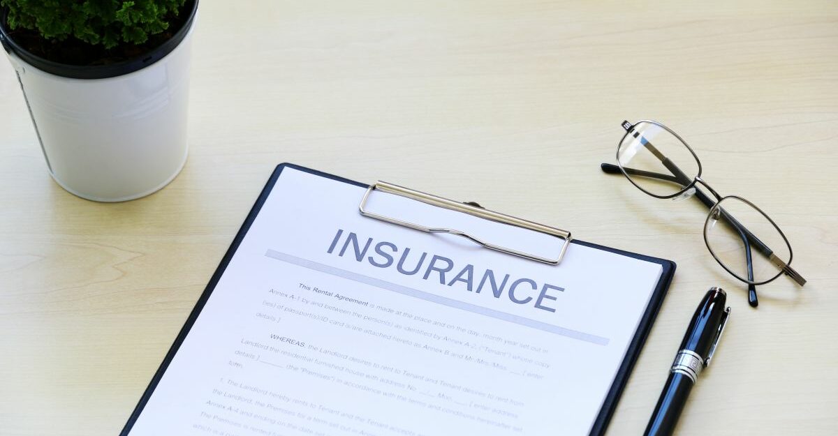 Insurance document on a clipboard with glasses and a pen on a desk — representing Canada Life long-term disability coverage and claims.