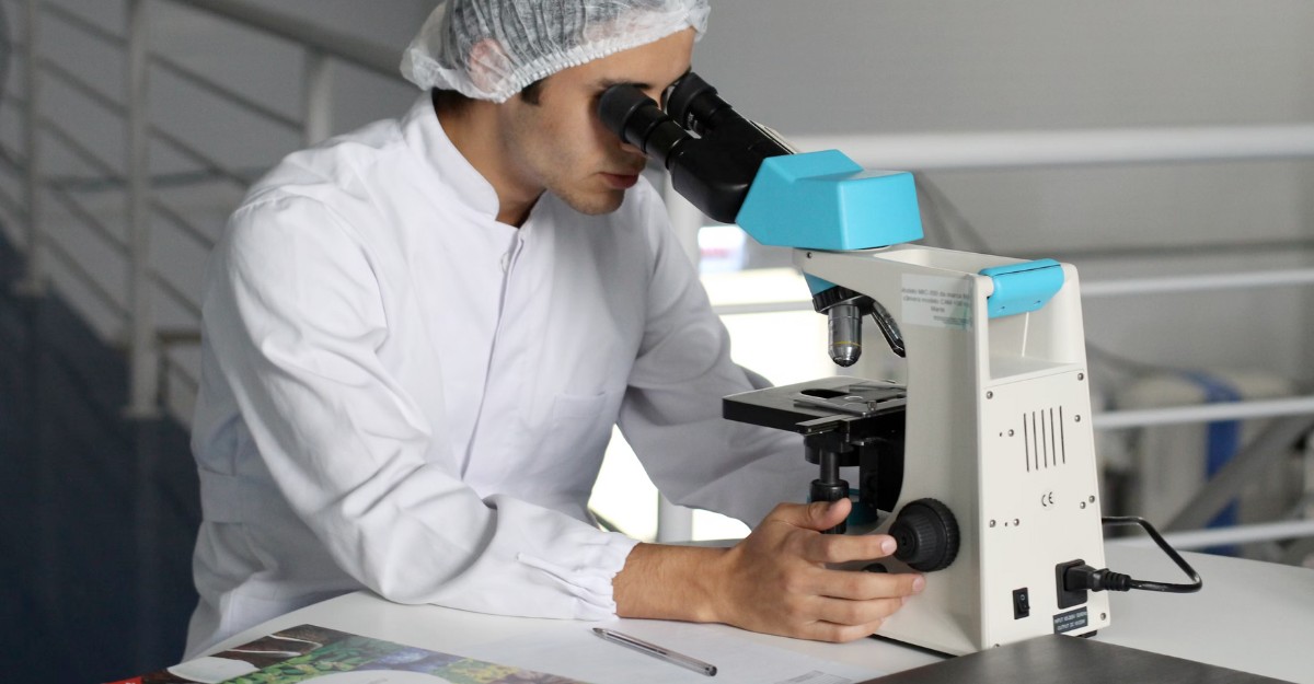recursion-layoffs-severance-pay A scientist studies a slide under a microscope. (Photo: Lucas Vasques / Unsplash)