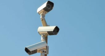A photo of surveillance cameras on a pole. (Photo: Jürgen Jester / Unsplash)