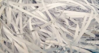 Multiple shredded documents sit in a pile.
