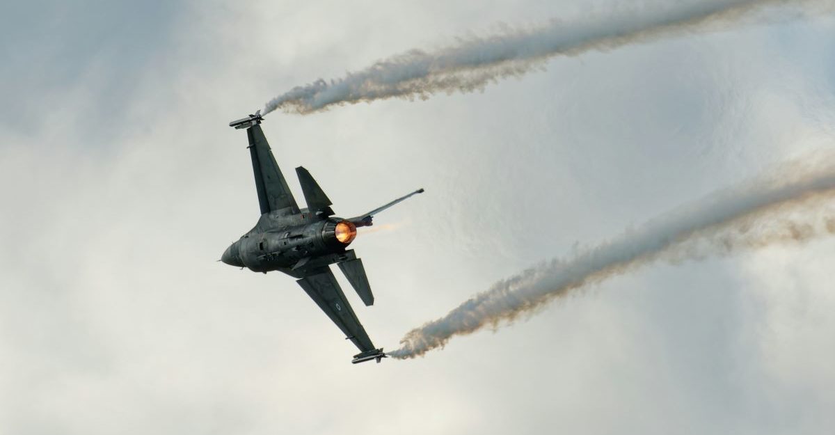 cae-layoffs A close up shot of a fighter jet, potentially in use by CAE, streaking across the sky.