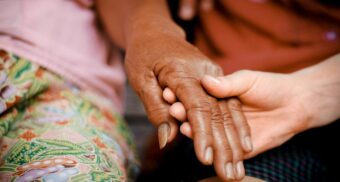 A person is comforted by another individual in a time of need. (Unsplash)