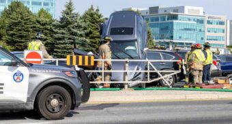 A photo of a grey Lexus on top of another vehicle on Highway 404 near the Woodbine/Steeles off-ramp. (Photo supplied to CTV News Toronto)