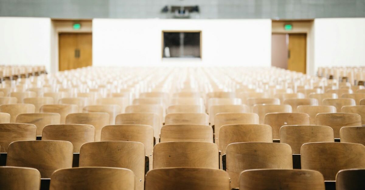 university-college-lecture-hall-post-secondary-education Rows of empty seats in a lecture hall at a university, college, or post secondary institution.