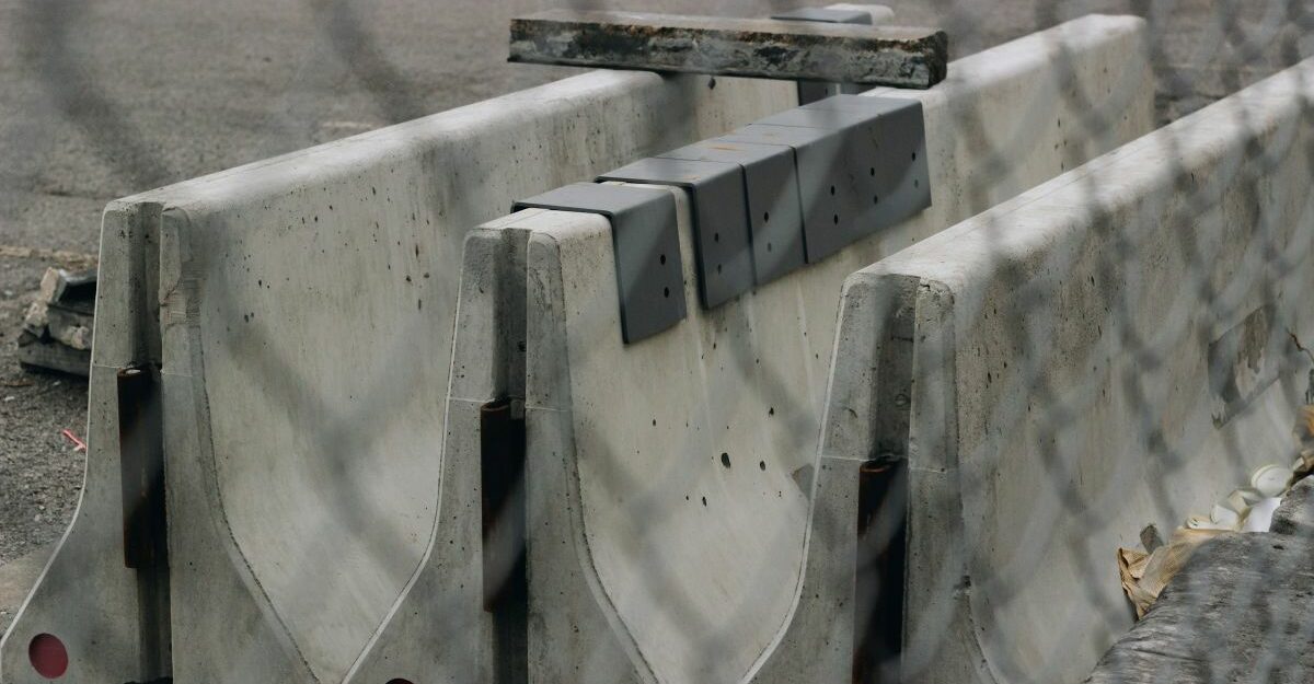 Three concrete barriers are lined up in a row.
