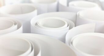 Rolls of paper on a table. (Photo: Tom Kenar / Unsplash)