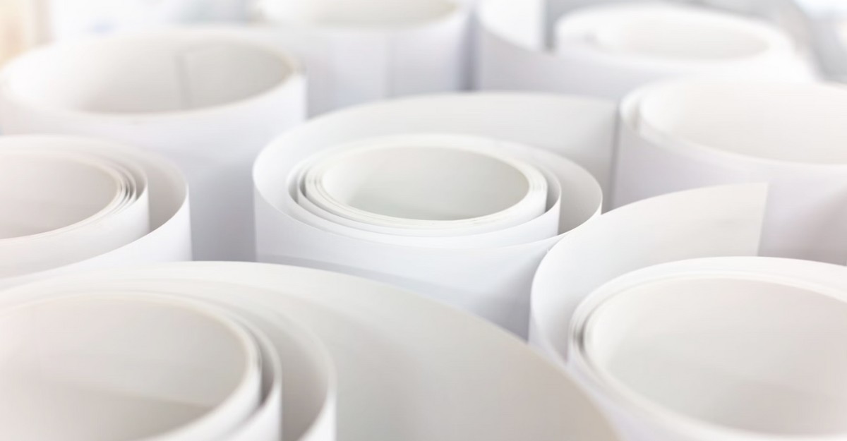 Rolls of paper on a table. (Photo: Tom Kenar / Unsplash)