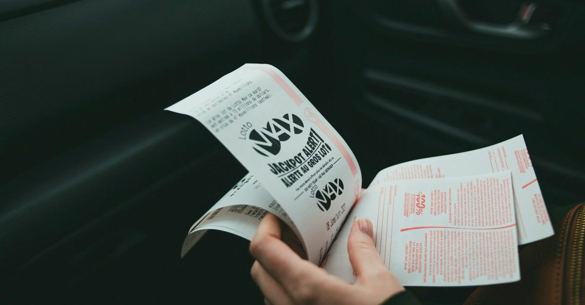 lottery-tickets-gambling Somebody clutches a handful of lottery tickets.