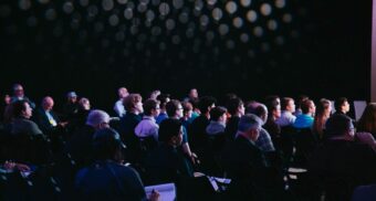 A large group of people attend an event.