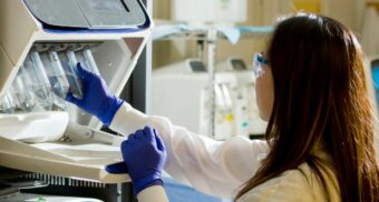 teva-layoffs-severance-pay A scientist looking at various samples in a lab. (Photo: National Cancer Institute / Unsplash)