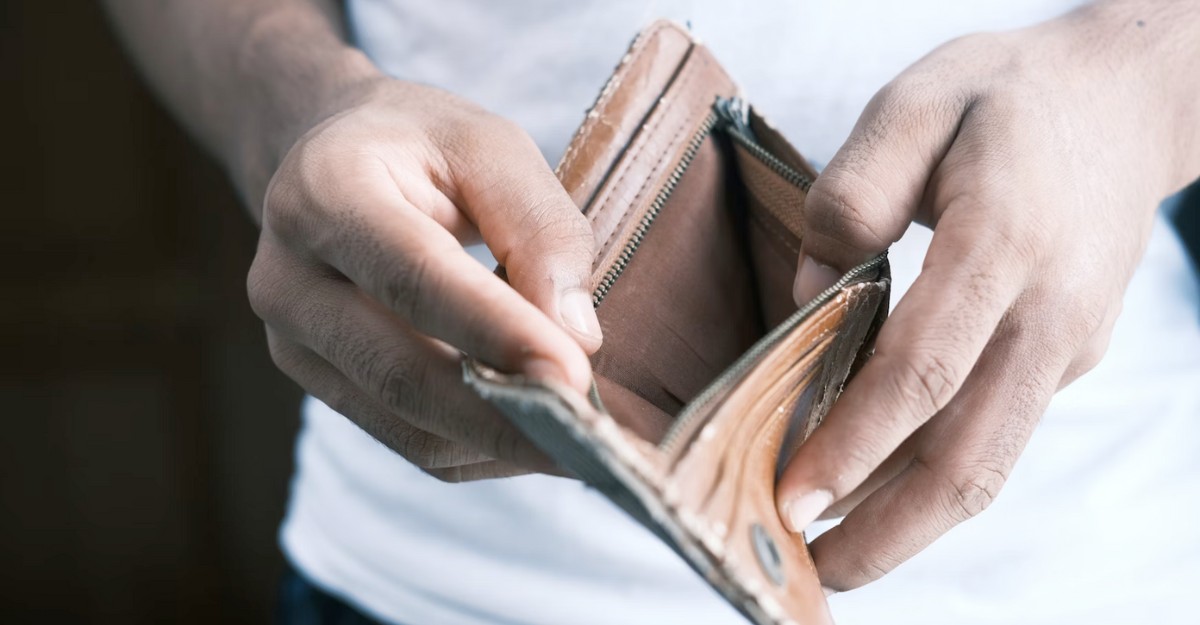 toronto-cost-of-living-increase-poll-october-2025 A man opens a brown leather wallet to reveal that it's empty. (Photo: Towfiqu Barbhuiya / Unsplash)