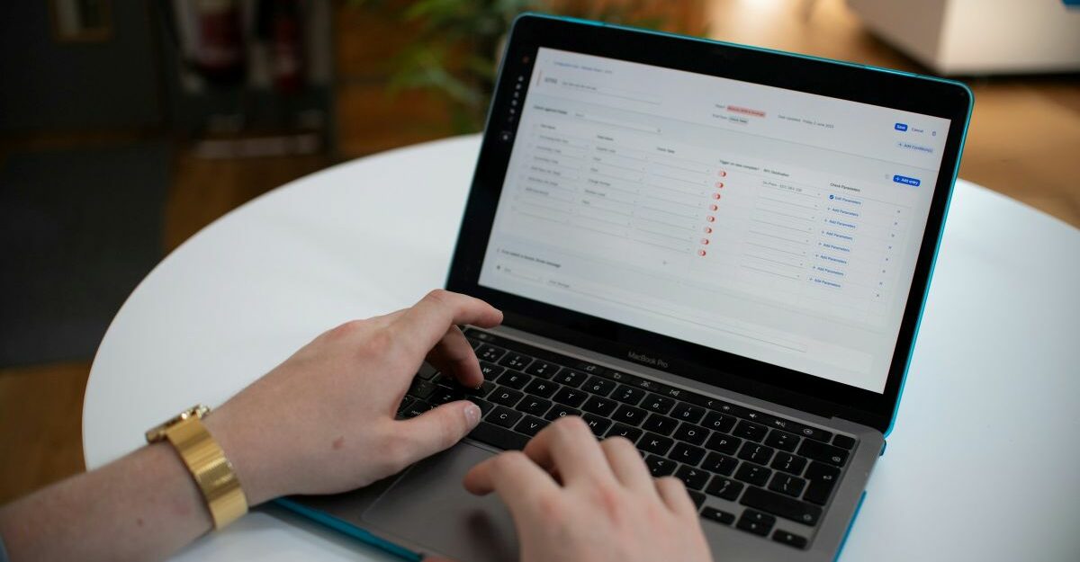 Person using a laptop to fill out an online application form, representing the process of applying for EI sickness benefits in Canada.