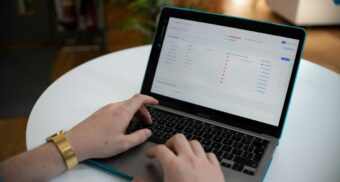 Person using a laptop to fill out an online application form, representing the process of applying for EI sickness benefits in Canada.