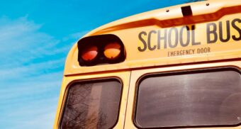 The rear of a school bus. (Photo: Lnicolern / Unsplash)