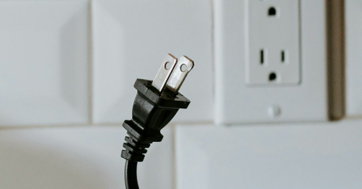 A close-up of an unplugged power cord near a wall outlet, symbolizing the right to disconnect from work in Ontario.