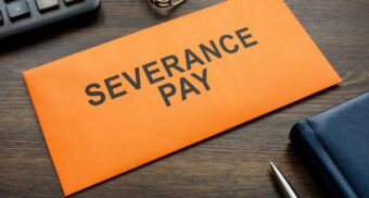 Severance pay envelope on a desk, representing a termination offer and common law severance assessment in Alberta.