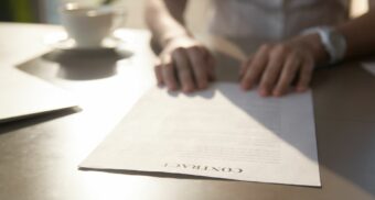 Employee reviewing a non-compete clause in an Alberta employment contract.