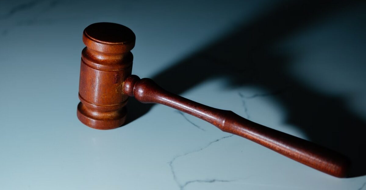 A wooden gavel on a marble table. (Photo: Wesley Tingey / Unsplash)