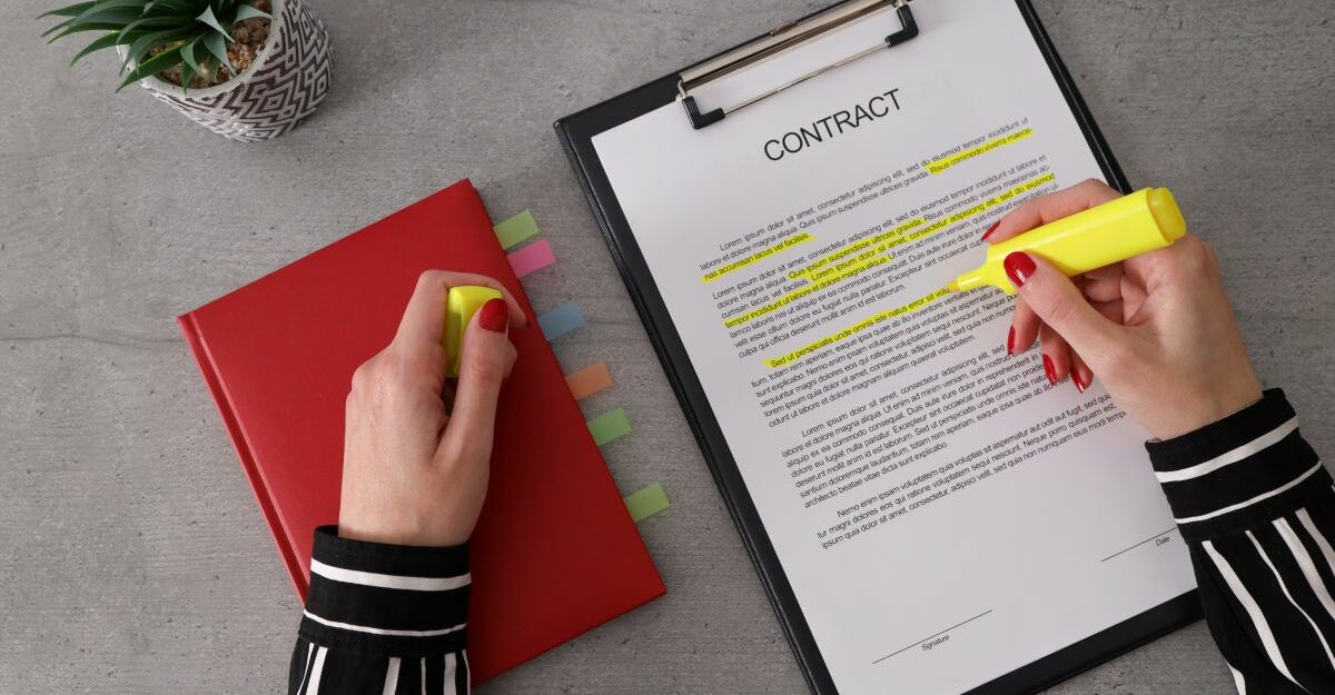 Reviewing an employment contract in BC with a termination clause highlighted.