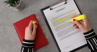 Reviewing an employment contract in BC with a termination clause highlighted.