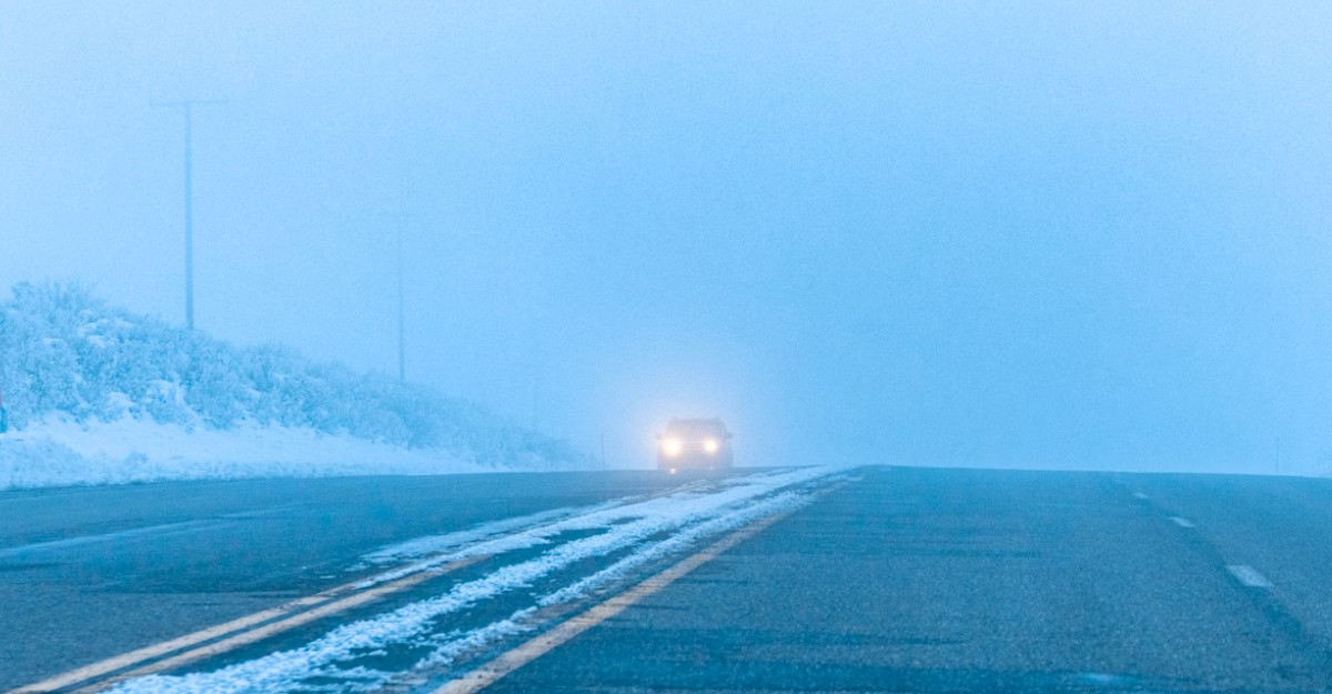 A vehicle driving on a road following a snowstorm. (Photo: Ross Stone / Unsplash)