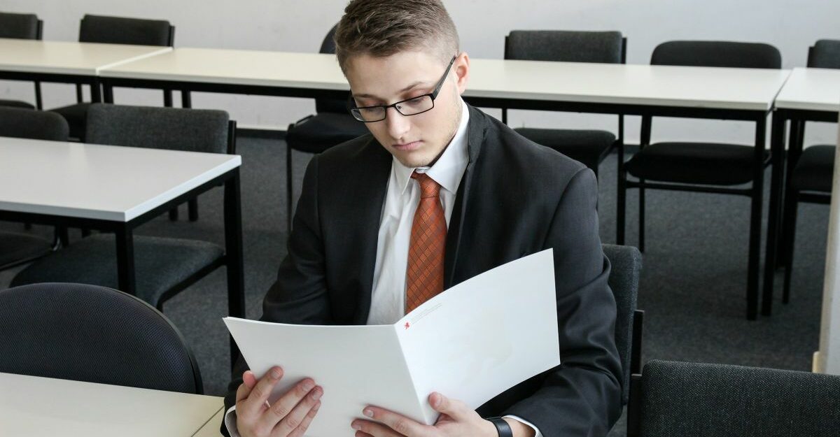 Job applicant reviewing paperwork during pre-employment screening in Canada.