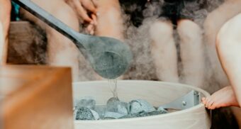 A group of people sitting in a sauna. (Photo: huumsauna / Unsplash)