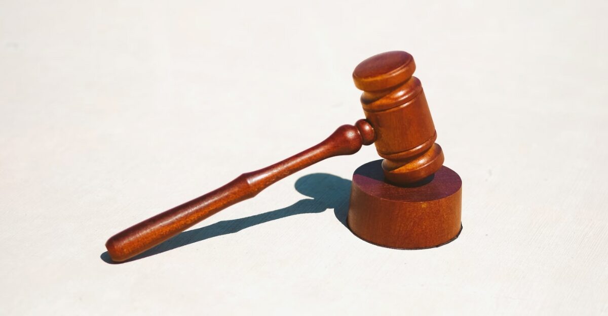A brown gavel on a white surface. (Photo: Tingey Injury Law Firm / Unsplash)