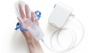 A person holding a respiratory device. (Photo: Mockup Graphics / Unsplash)