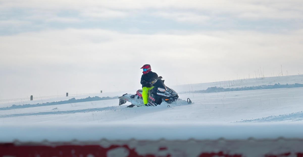 A person on a snowmobile. (Photo: livekaiah / Unsplash)