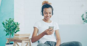 A woman listens to music in her headphones. (Photo: Vitaly Gariev / Unsplash)