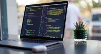 Code on a laptop near a window. (Photo: James Harrison / Unsplash)