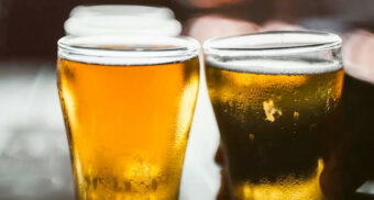 Multiple glasses of beer on a wooden table at a restaurant. (Photo: Teo Do Rio / Unsplash)