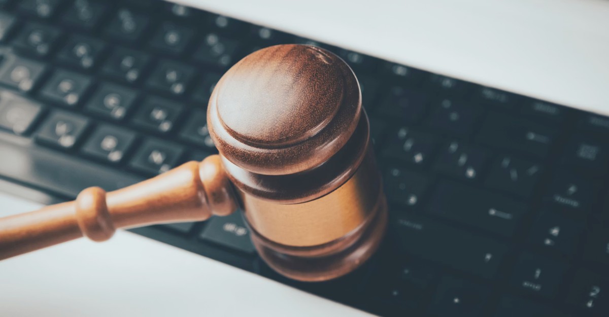 A wooden gavel in front of a laptop. (Photo: Sasun Bughdaryan / Unsplash)