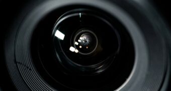A close-up of a camera lens. (Photo: Colin Lloyd / Unsplash)