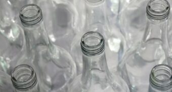 Glass bottles on a table. (Photo: Zimbarus / Unsplash)