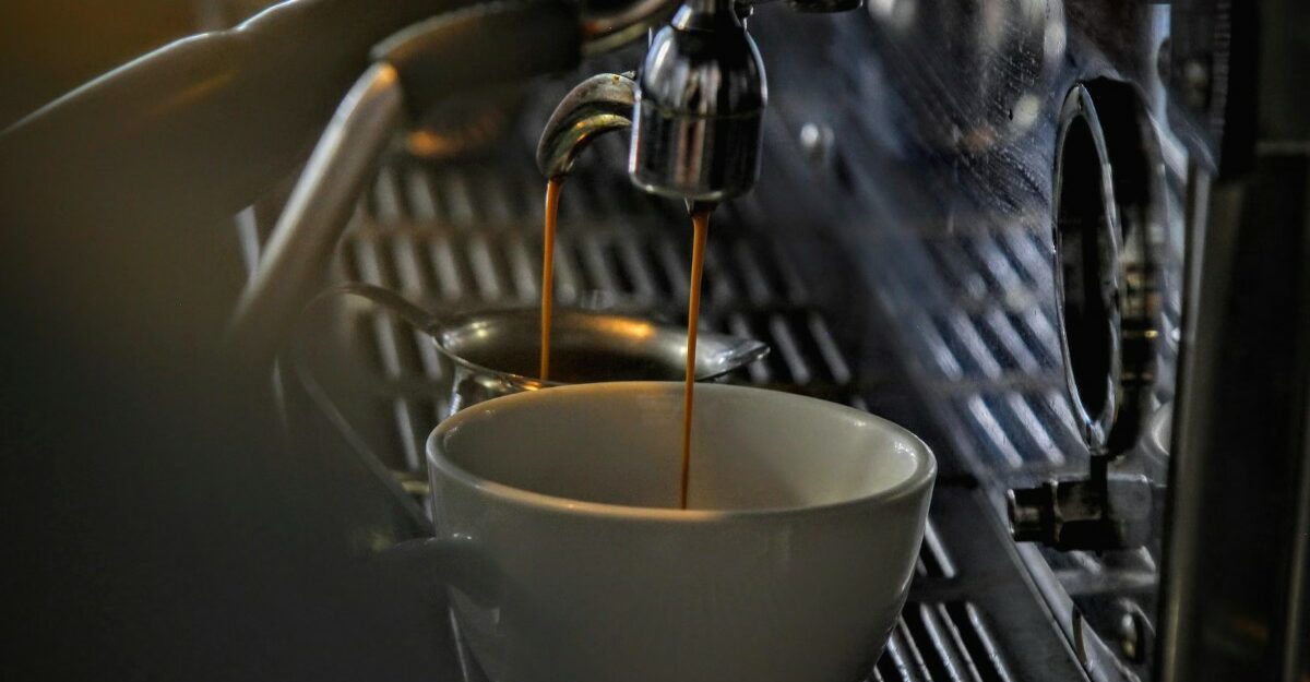 A coffee machine pouring coffee into a mug. (Photo: GC Libraries Creative Tech Lab / Unsplash)
