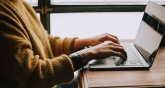 A businessperson typing on a laptop. (Photo: Christin Hume / Unsplash)